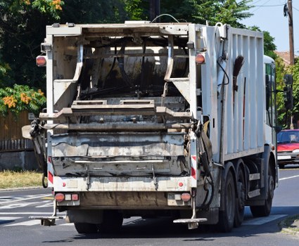 Staff using mechanical aids for heavy waste lifting